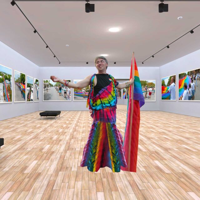 Gilbert Baker, joyfully holding the Rainbow Flag during the Sea to Sea Rainbow Flag unfurling at Key West Pride.